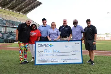 VACU and Feed More present check for Strike Out Hunger campaign