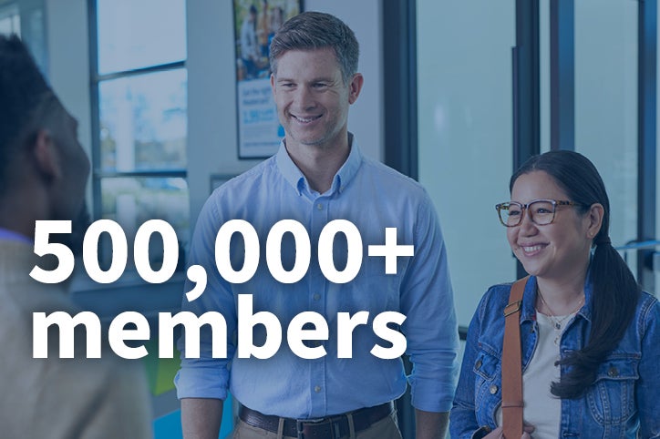 Couple smiling while talking to another individual with the text "500,000+ members" overlaid