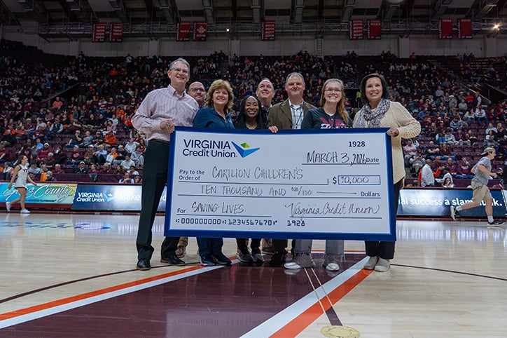 Virginia Credit Union and its Member One division presenting donation of $10,000 to Roanoke-based Carilion Children's Hospital at basketball game