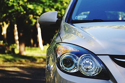 close up of silver car headlight