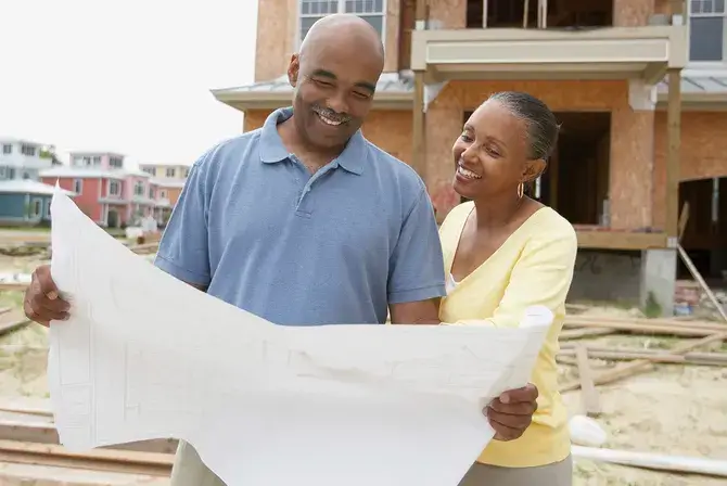 Couple looking at a blueprint of their new home