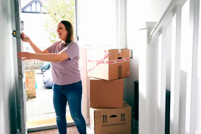 A woman moving into her home