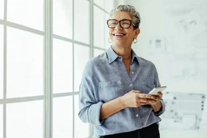 Woman smiling and looking at her phone