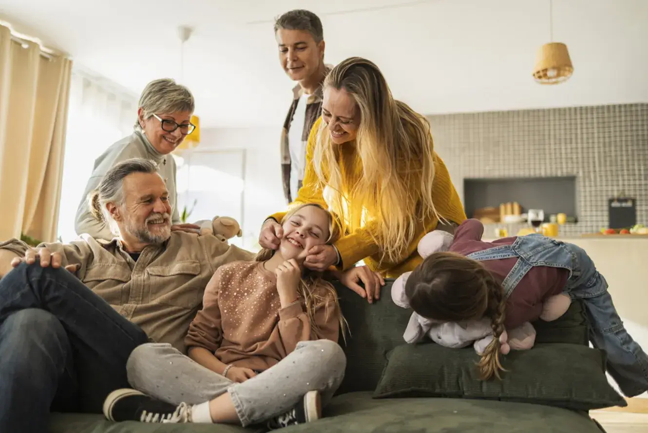 multi-generational family laughing together and smiling