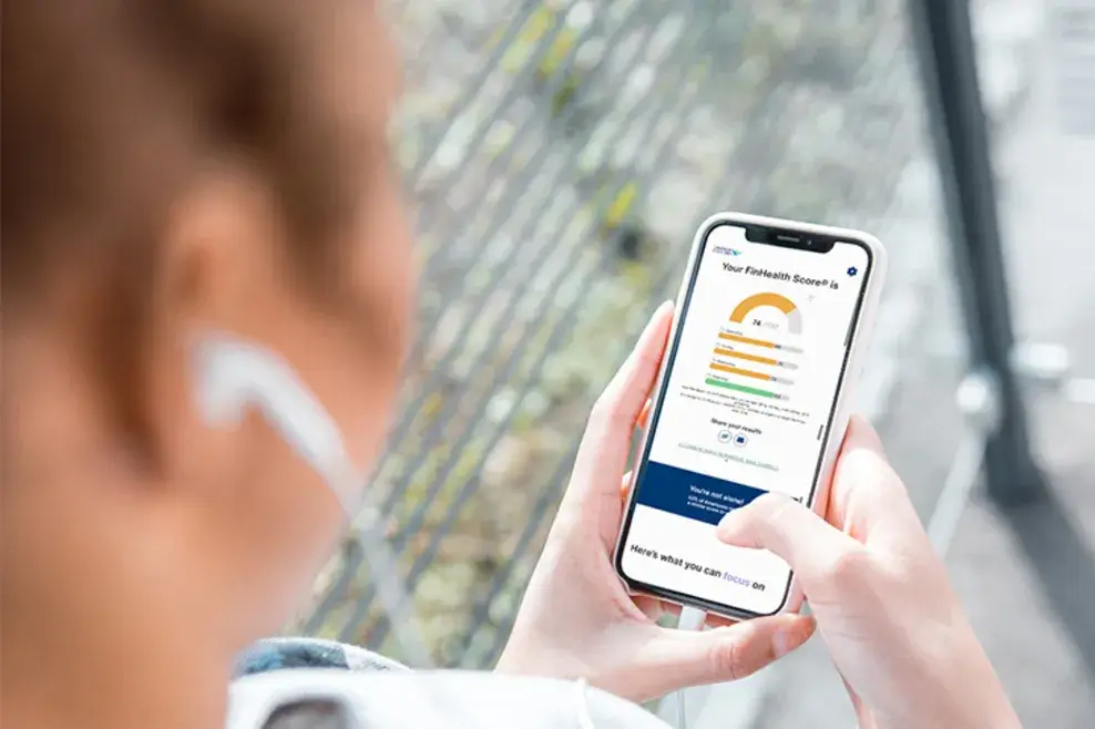 Person looking down on their phone with Financial Health Score showing on the screen