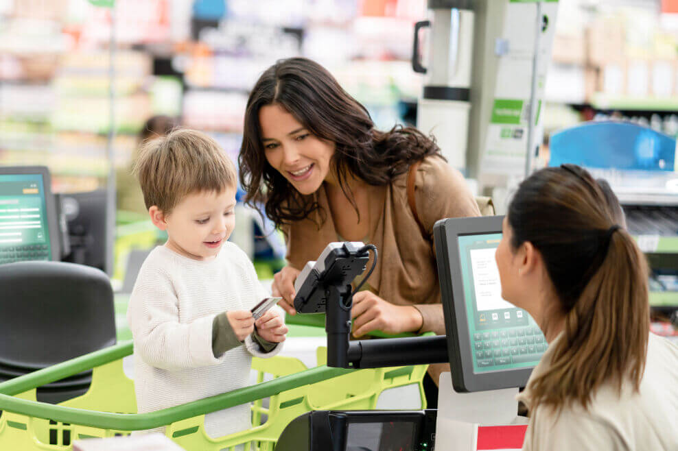 Mother with child at a checkout counter