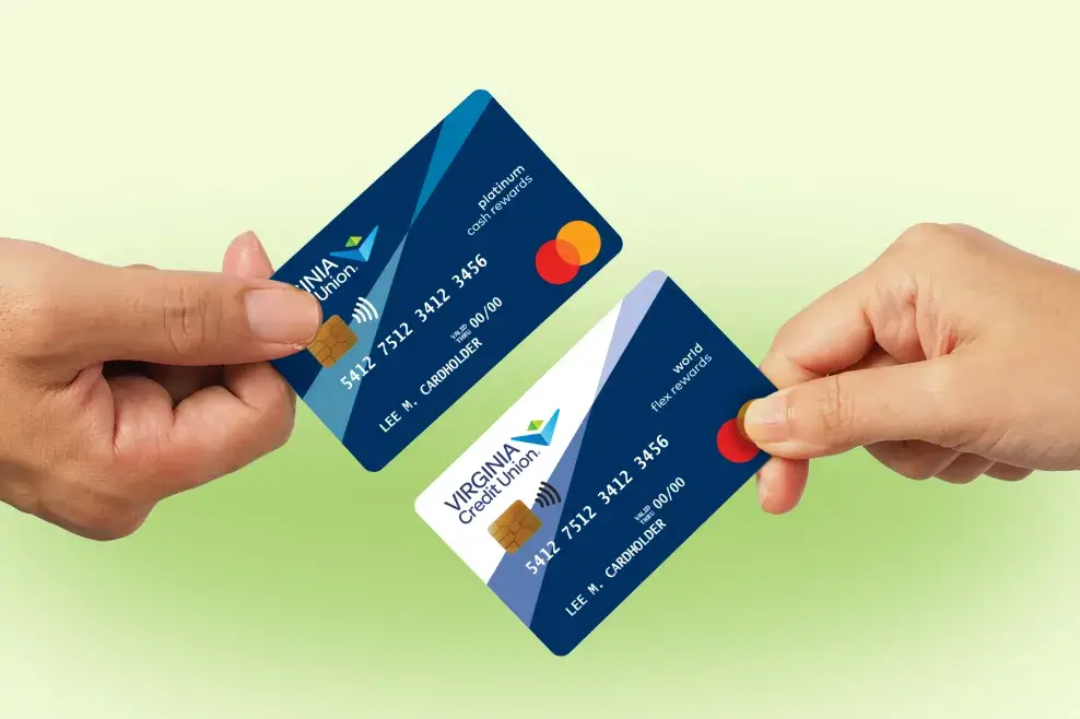 Hands hold two Virginia Credit Union Mastercard credit cards — a cash rewards card and a flex rewards card — in front of a gradient green background.