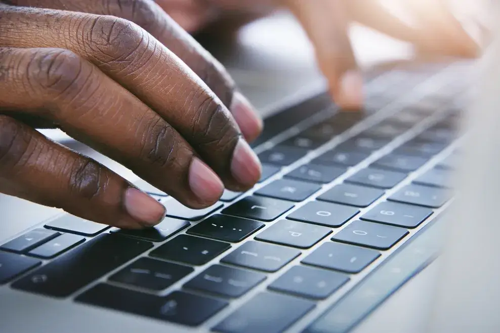 hands on a computer keyboard