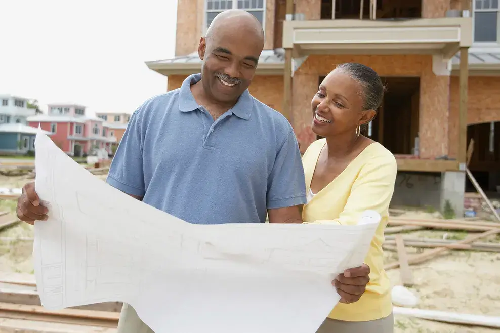 Couple looking at a blueprint of their new home