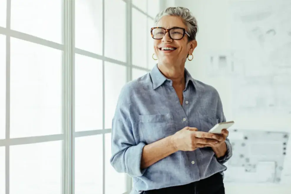 Woman smiling and looking at her phone