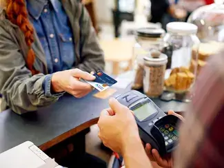 Person using credit card at register.
