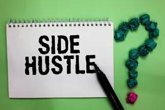 A notebook with the word "Side Hustle" written in it.