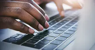 hands on a computer keyboard