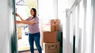 A woman moving into her home