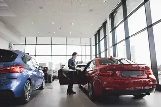 shopping for red car at dealership