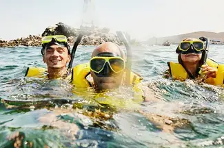 Family snorkeling in the ocean. 