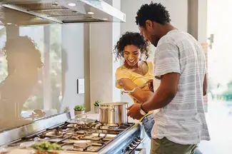 Couple cooking dinner in kitchen