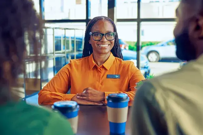 VACU employee smiles while assisting members