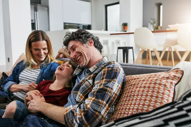 Family sitting on sofa