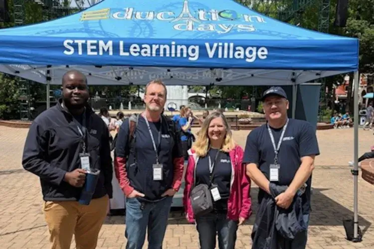GiSTEM volunteers standing outside of pop-up tent