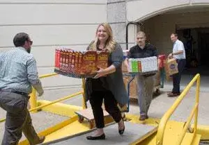 VACU employee delivering cereal