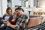 family sitting on sofa