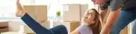 Couple moving in to house with moving boxes