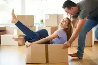 Couple moving in to house with moving boxes