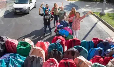vacu employees with backpacks