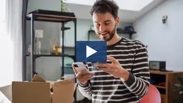 A man making a credit card purchase on his mobile phone 