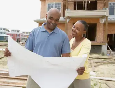 Couple looking at a blueprint of their new home
