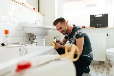 A man fixing his bathtub
