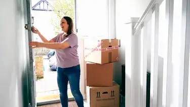 A woman moving into her home