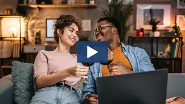 couple enjoying glass of wine on the couch