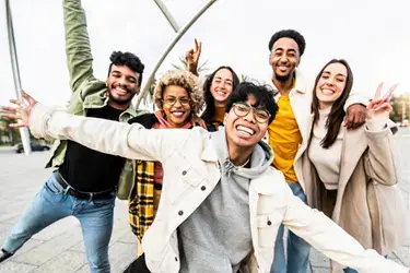 Group of young adults smiling.