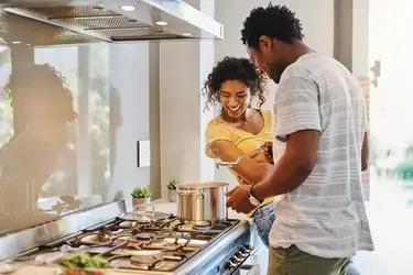 Couple cooking dinner in kitchen