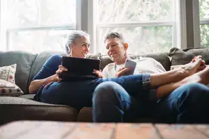 Couple doing finances while relaxing. 