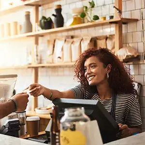 cashier handing card back to customer