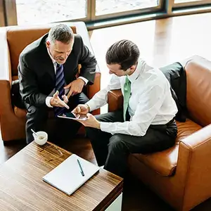 two men meeting while sitting in chairs